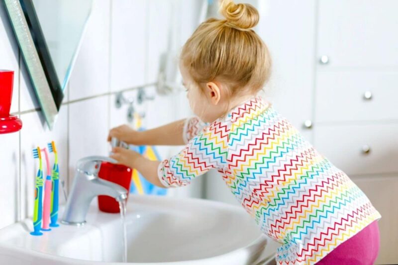 peuter wast haar handen met zeep